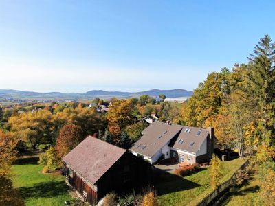 The house and the village of Hodousice in the autumn landscape from above
