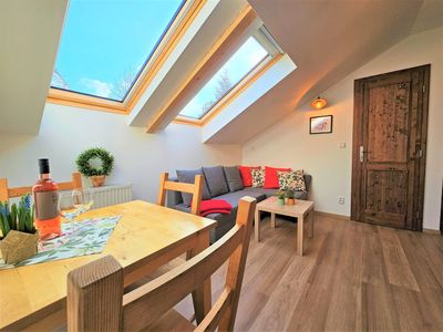 The dining table and sofa under the roof windows