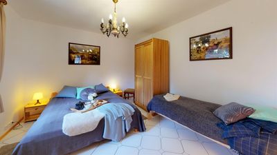 A bedroom with a double bed and a single bed