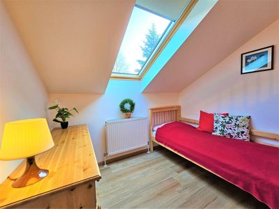 A single bed by the roof window