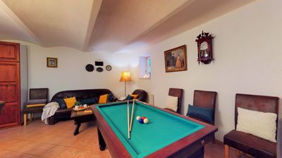 The billiard table and seating in the common room