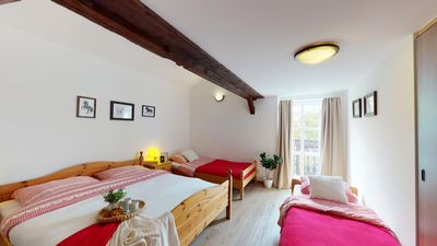 A bedroom with beds by the window