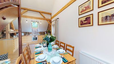 A laid dining table with the kitchen behind