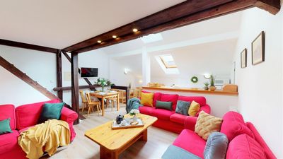 The living room with three sofas and a dining table