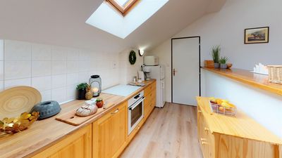 The kitchen with an oven and a wooden worktop