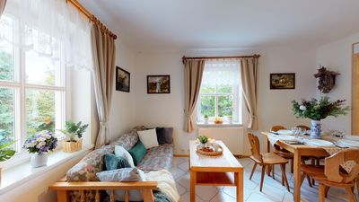 The living room with a sofa and a dining table