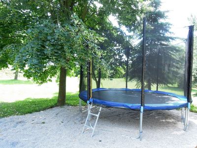 Trampoline in the shade of the trees