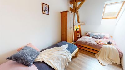The attic bedroom under the open roof structure