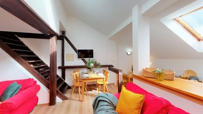 The living room with the staircase and the dining corner
