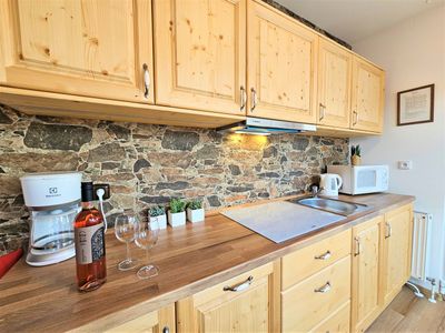 The kitchen units with a coffee machine, kettle and microwave